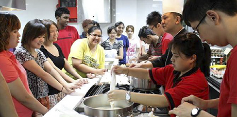  READY TO BAKE: Chef Loke Hoi Weng in the midst of briefing participants on pastry-making during the "Culinary Workshop for Charity".