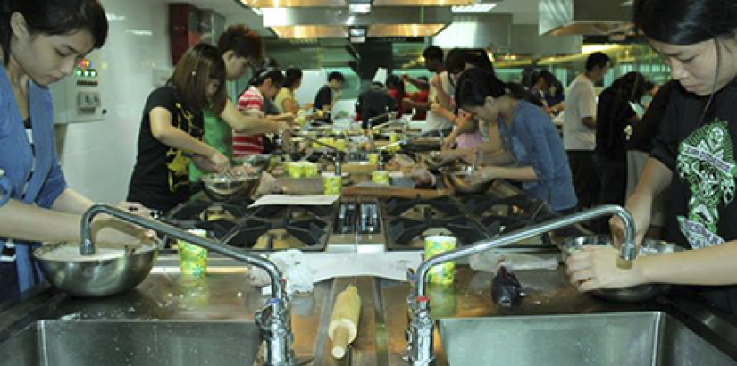  HANDS-ON: Workshop participants having a fun time mixing dough during the "Culinary Workshop for Charity".