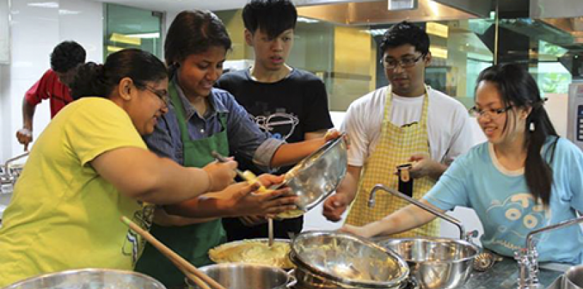 HANDS-ON:Workshop participants having a fun time mixing dough during the "Culinary Workshop for Charity".