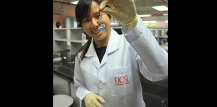 A high school student participant of the Lady Gaga workshop showing off DNA that she isolated from her cheek cells and kept in a cute bottle, as part of the workshop.