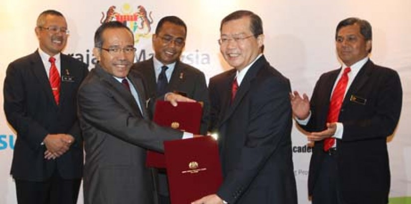  SEALING THE DEAL: MOHE secretary general YBhg. Datuk Ab Rahim bin Md Noor (second from left) in the midst of congratulating UCSI deputy vice-chancellor (Academic Affairs and Research) Prof. Emeritus Dr. Lim Koon Ong (fourth from left) after the MoU signi