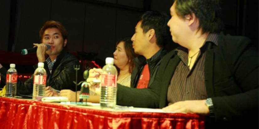 Dennis Lau giving his opinion on one of the performances, while (from right) Lam, Dino and Ms. Ooi, look on