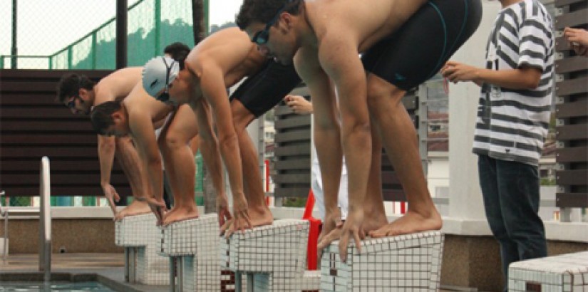 Participants at the starting blocks of a swimming finals