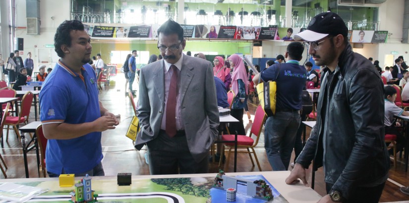 Dr Khan observing the various robotic projects.