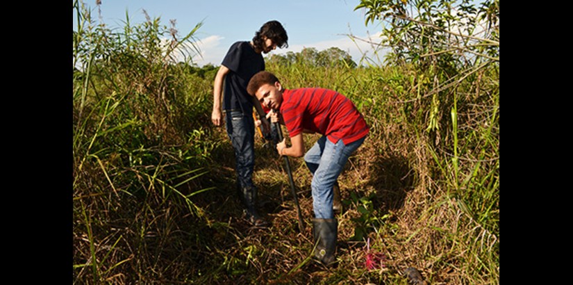  FOR A GOOD CAUSE: UCSI University's Engineering students in the midst of digging holes to plant their saplings at the Raja Musa Forest Reserve.